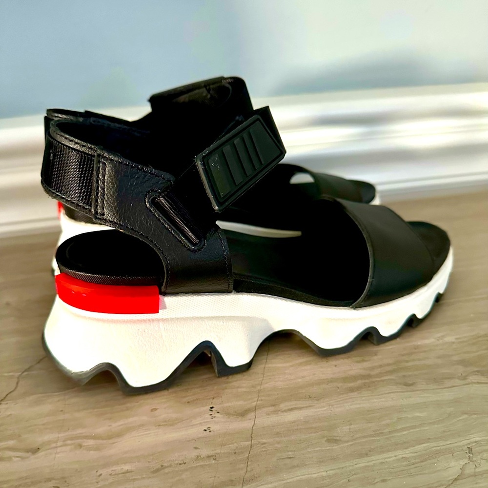 Sorel Kinetic Impact black sandals with ankle straps.